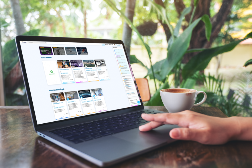 The Mydea user interface can be seen on the screen of a laptop.